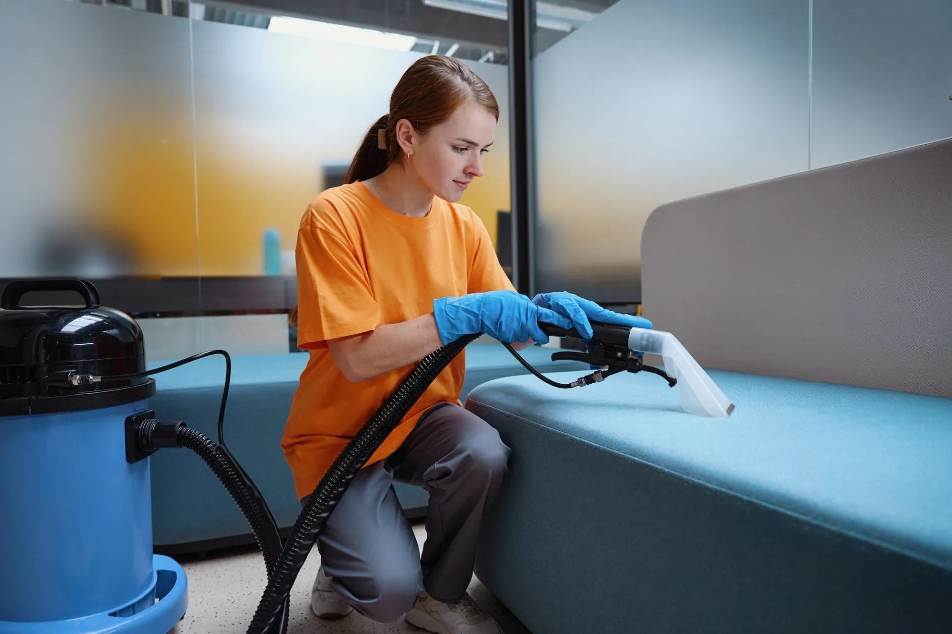 focused-cleaning-service-worker-vacuum-cleaning-the-sofa-e1680687845640-7